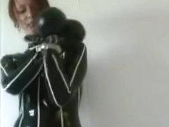Redhead in heavy rubber and metal cuffs