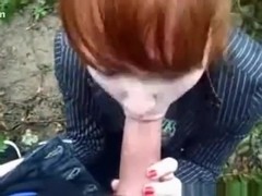 Ponytailed redhead girl gives her bf a pov blowjob in nature