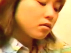A redhead Japanese girl is masturbating her pussy