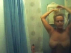 Big breasted blonde captured on a shower spy cam