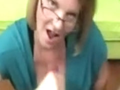 Busty mature with glasses milking a lizard on the couch