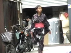 Cute Asian in a jukata has boob sharking on the street.