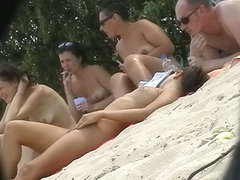 Hot babes filmed lounging on a nudist beach