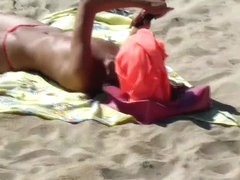 sunbathing topless