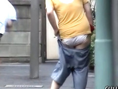 Street sharking with woman in jeans shorts 