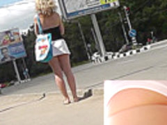 Plump blonde in white skirt and panties in upskirt clip