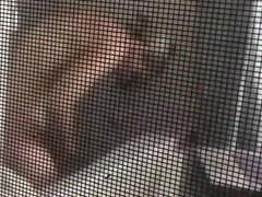 Voyeur secretly films his milf neighbor through window