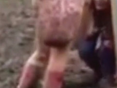 Hippie girl peeing in the mud at concert