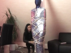 Lycra and shrink wrap mummification, and rope harness