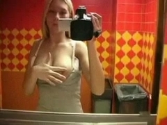 Blonde girl films herself in bathroom