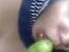 Muslim girl uses a veggie dildo and fingers her pussy