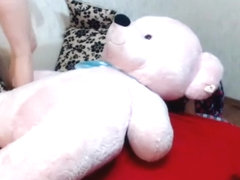 Slender naked hotty plays with large teddy bear