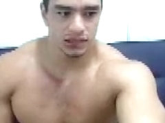 Muscular guy masturbating licks his fingers full of cum