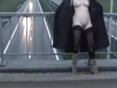 Exhibitionist wife in stockings and long coat flashing motorists on a bridge