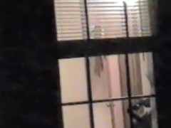 Naked bimbo is dancing and getting spied thru window