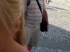 Sexy girl shows tits in the middle of a lively square