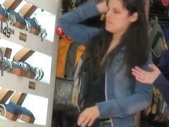 Dark hair sweetie gets filmed by a voyeur as she works in the watch department