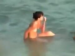Hidden cam video with a slim brunette getting fucked on a beach