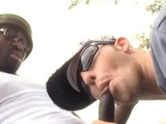 Gay guy gives interracial blowjob out in the open