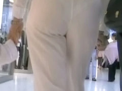 Hot mature babe in white pants in candid street video