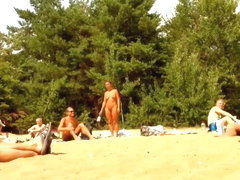 Wives and their husbands sunbathing at the nudist beach