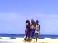 A lucky man on the beach with two ebony nymphs