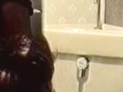 Toilet cam records amateur rubbing pussy through panty