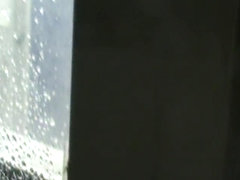Topless girl in jeans with wet head on window voyeur video