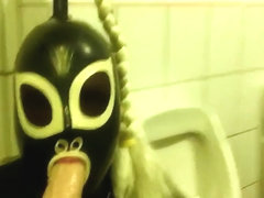 Rubberdoll Monique - Blowjob training in a public toilet