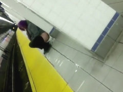 Wicked purple-haired babe makes water at the subway