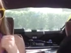 Blonde bimbo gives a road head while test driving her car