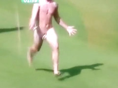 Streaking guy runs around the football pitch