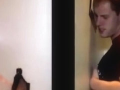 Teens in a hot scene at a glory hole room