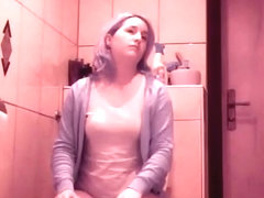 Woman using her toilet to take a piss