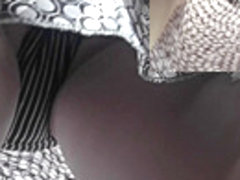 Real upskirt video of the amateur woman in light dress