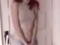Redhead college girl pees her tight pants after waiting too long